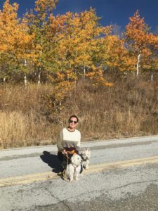 Julie K. and white dogs with fall colors at SnowBasin