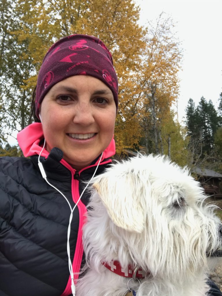 Julie K and dog in fall colors at lake house