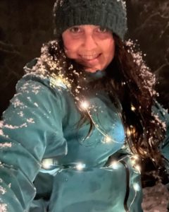 Julie K in the snow with fairy lights