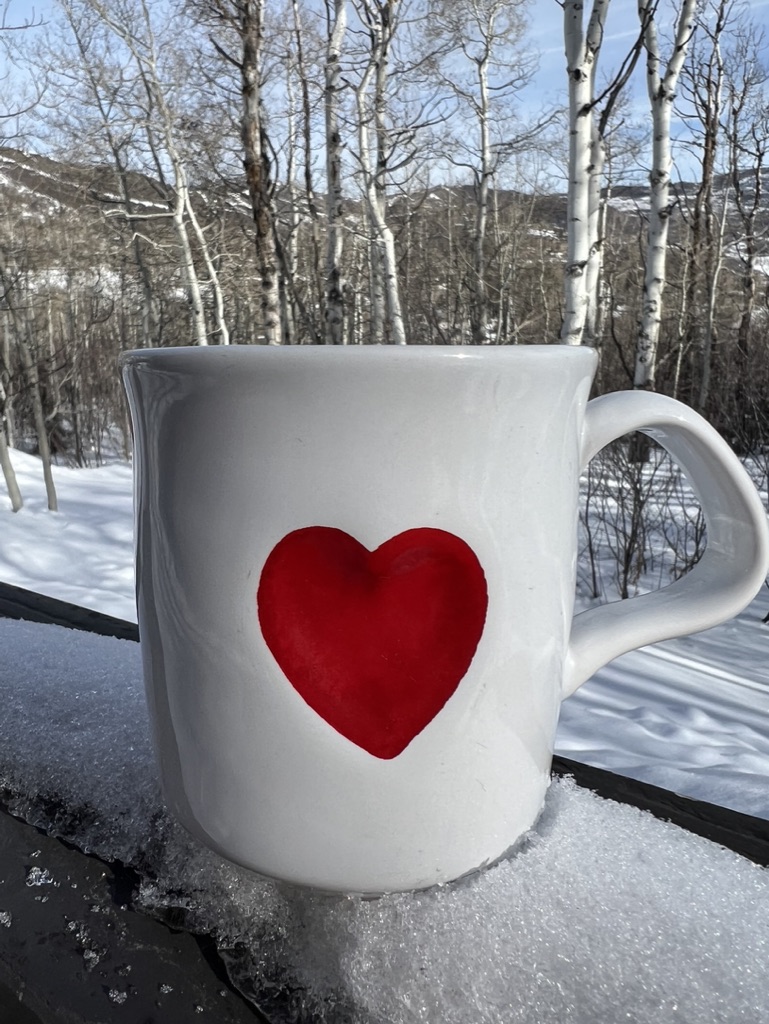 Heart mug on the rail looking over aspen trees at Snowmass airbnb