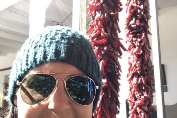 Julie K travel with strings of chili peppers in Santa Fe New Mexico