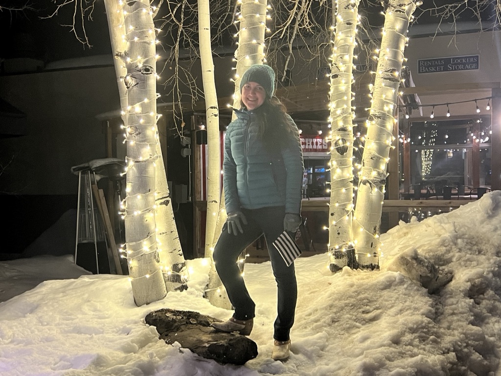Julie K travel in Snowmass Village with lights at night