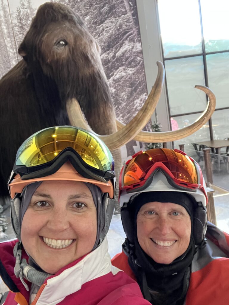 Julie K and friend in front of giant mammoth at Mammoth ski area