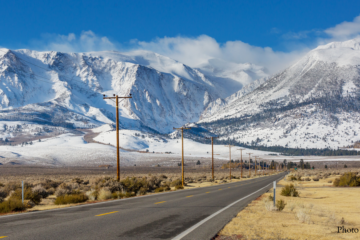 Lonely highway and snow covered mountains in Nevada