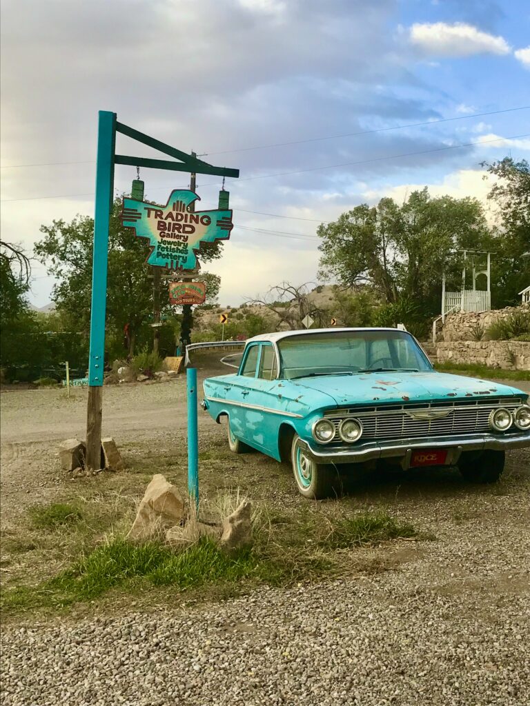 Turquoise sign and old car in Madrid NM along the Turqoise Trail
