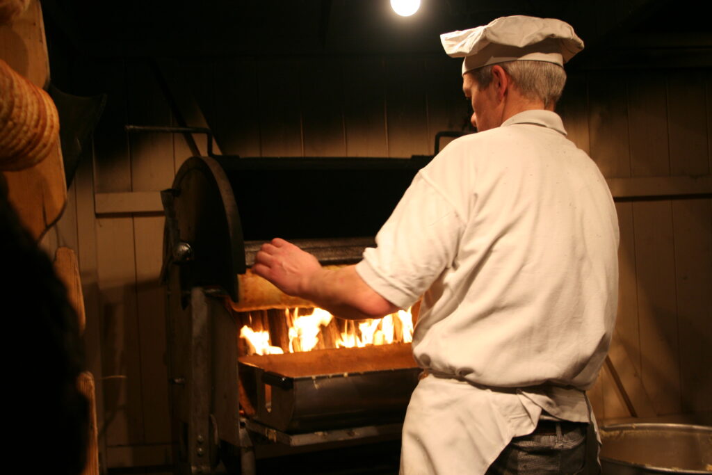Baumkuchen being baked traditionally over the fire