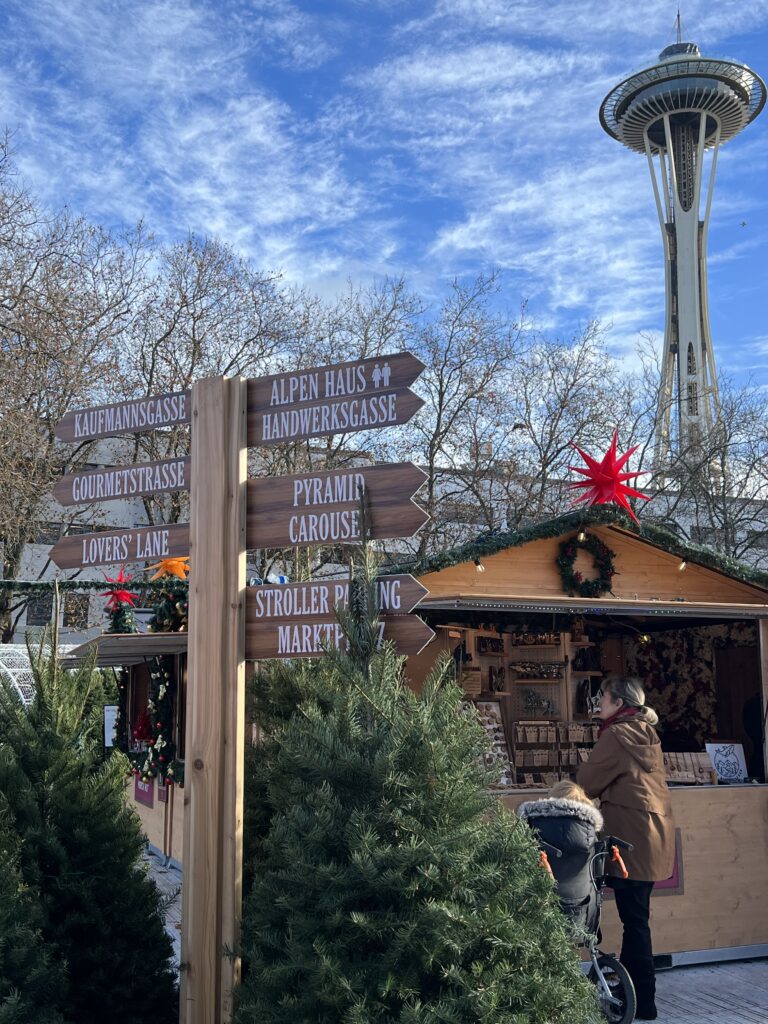 Space Needle and street signs at the Seattle Christmas Market