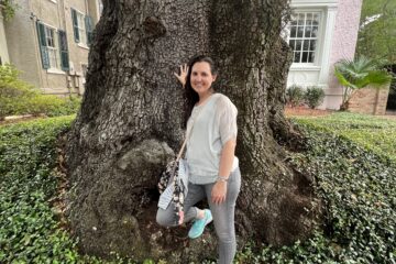 Julie K standing with a tree in the Garden District