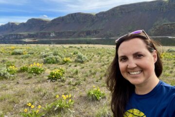 Julie K in the coulee along lake and yellow wildflowers