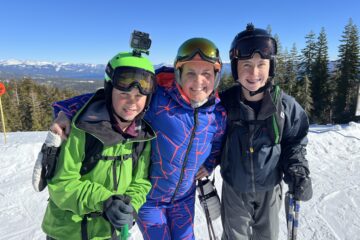 Julie K, G1 and G2 on top of the mountain skiing